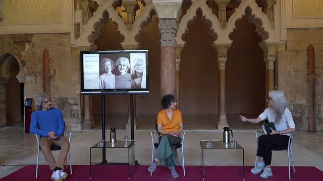 poster Conversaciones en la Aljafería con Estrella García, Miguel Quiroga y Mercedes L. Caballero
